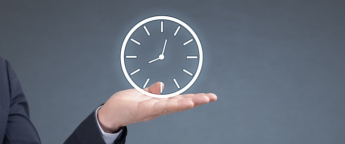 Illuminated clock above a mans hand